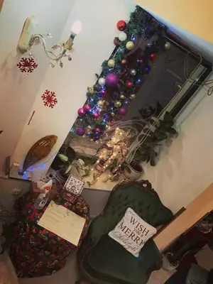 a living room with a christmas tree and a chair at Hi Boutique Hotel in Varna City