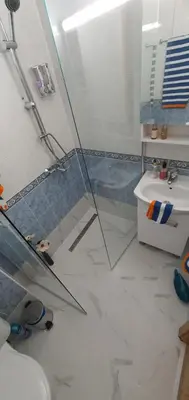 a bathroom with a glass shower and a sink at Alex Beach Apartment in Sveti Vlas