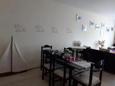 a dining room with a table and some chairs at Villa Bonita Apartment in Sunny Beach