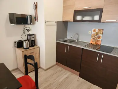 a small kitchen with a sink and a microwave at Villa Bonita Apartment in Sunny Beach