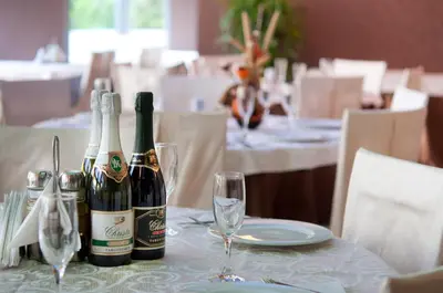 two bottles of wine sitting on a table with glasses at Regata Palace Hotel in Sunny Beach