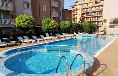 a large swimming pool with lounge chairs in a building at Tropics Hotel - Ultra All Inclusive in Sveti Vlas