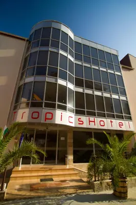 a building with a sign on the front of it at Tropics Hotel - Ultra All Inclusive in Sveti Vlas