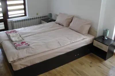 a bed in a room with two nightstands and a bed sidx sidx sidx at TOP CENTER , MODERN AND QUIET APARTMENT in Burgas City