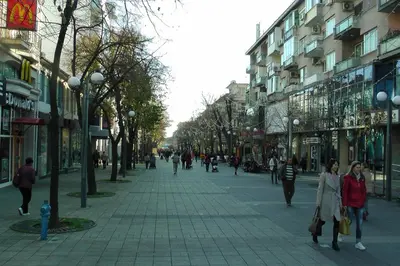 a city street with people walking down a sidewalk at TOP CENTER , MODERN AND QUIET APARTMENT in Burgas City