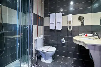 a bathroom with a toilet and a shower and a sink at Karolina Hotel in Sunny Beach