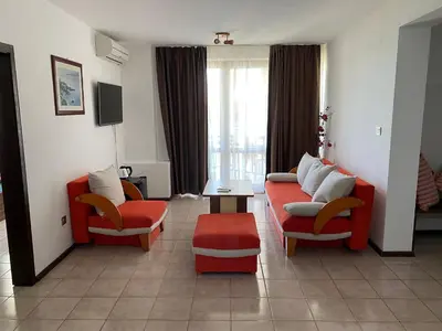 a living room with two chairs and a couch and a table at Villas Sozopol in Sozopol