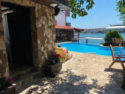 a stone house with a swimming pool and a patio at Villas Sozopol in Sozopol