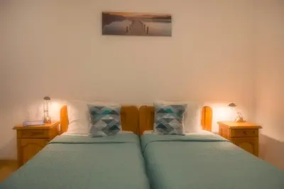 two twin beds in a room with two lamps at Sun City I Apartments in Sunny Beach