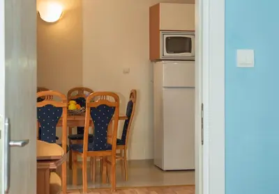 a kitchen with a table and chairs and a microwave at Sun City I Apartments in Sunny Beach