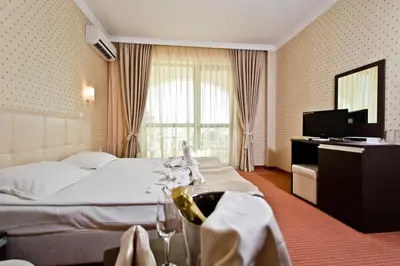 a hotel room with a bed and a television at Saint George Palace Hotel All-inclusive in Sveti Vlas