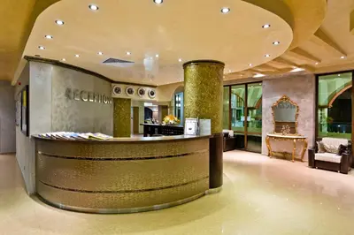 a lobby with a bar in a building at Saint George Palace Hotel All-inclusive in Sveti Vlas
