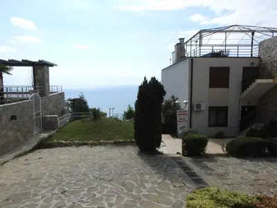 a house with a view of the ocean at Dolce Vita Apartment in Sveti Vlas
