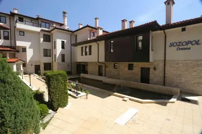 a group of buildings with a courtyard in front at Sozopol Dreams Apartments in Sozopol