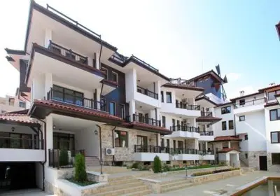 a large white building with stairs in front of it at Sozopol Dreams Apartments in Sozopol