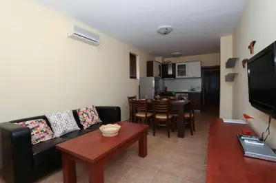 a living room with a couch and a table at Sozopol Dreams Apartments in Sozopol