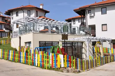a colorful fence in front of a building at Villa on the Black Sea in Sunny Beach