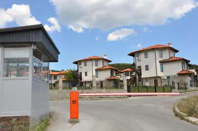 a building with an orange object in front of some houses at Villa on the Black Sea in Sunny Beach