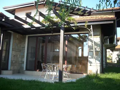 a patio with a table and chairs on a house at Villa on the Black Sea in Sunny Beach