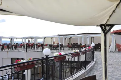 a balcony of a building with tables and chairs at Villa on the Black Sea in Sunny Beach