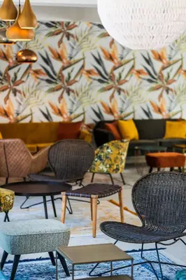 a group of chairs and tables in a room at Zefir Hotel in Sunny Beach