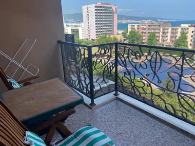 a balcony with a table and a view of a city at Barcelo SeaView Apartment in Sunny Beach