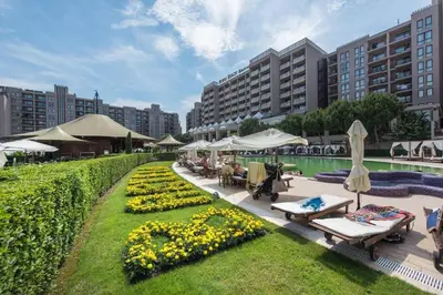 a resort with a garden with chairs and umbrellas at Barcelo SeaView Apartment in Sunny Beach