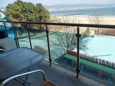 a balcony with a bench and a view of the beach at Apartment Sianie в центъра на Слънчев бряг, само на няколко крачки от плажа in Sunny Beach