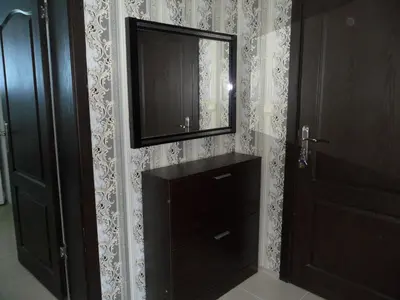 a bathroom with a dresser and a mirror next to a door at Apartment Sianie в центъра на Слънчев бряг, само на няколко крачки от плажа in Sunny Beach