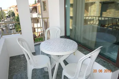 a white table and chairs on a balcony at КЪЩА