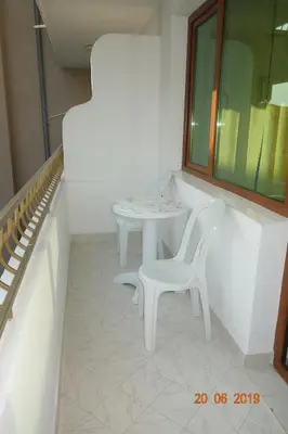 a white table and a white chair in a room at КЪЩА
