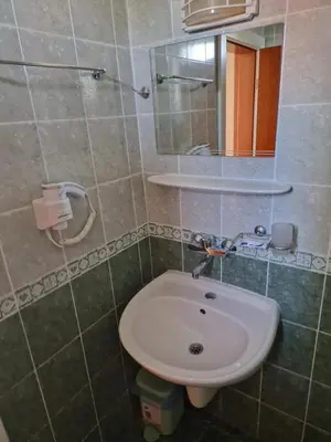 a bathroom with a sink and a mirror at Family Hotel Romantik in Sunny Beach