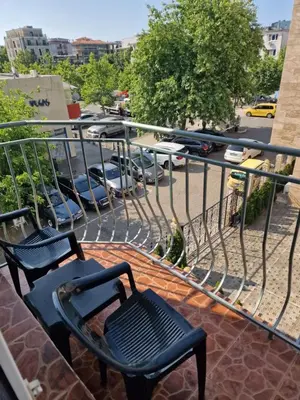 a balcony with two chairs and a view of a parking lot at Family Hotel Romantik in Sunny Beach