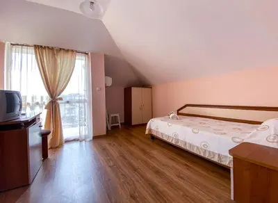a bedroom with a bed and a large window at Vanessa Family Hotel in Ravda