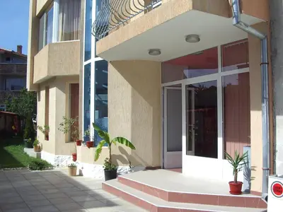 a facade of a building with potted plants at Vanessa Family Hotel in Ravda