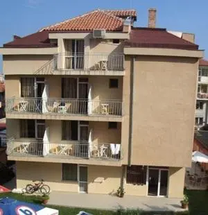a tall building with chairs on the balconies at Vanessa Family Hotel in Ravda