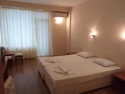 a hotel room with two beds and a window at Hotel Seasons 2 in Sunny Beach