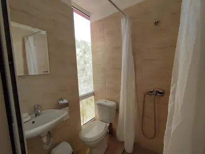 a bathroom with a toilet and a sink and a shower at Hotel Seasons 2 in Sunny Beach