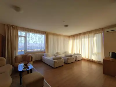 a living room with white furniture and a large window at Hotel Seasons 2 in Sunny Beach