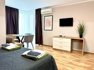 a bedroom with a bed and a desk and a table at Sineva Del Sol Apartments in Sveti Vlas