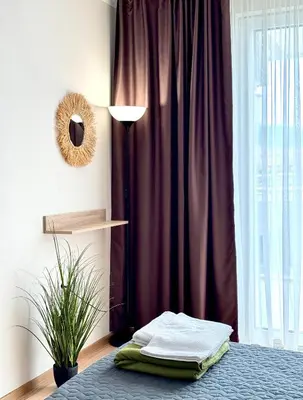 a bedroom with a bed with a purple curtain at Sineva Del Sol Apartments in Sveti Vlas