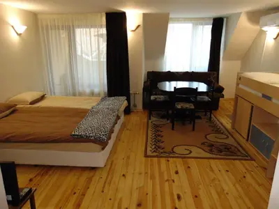a bedroom with a bed and a table and a chair at Burgas Central Aleksandrovska in Burgas City