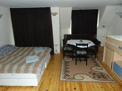 a bedroom with a table and a bed and a table and chairs at Burgas Central Aleksandrovska in Burgas City