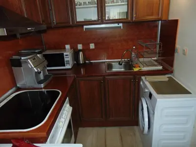 a small kitchen with a sink and a microwave at Burgas Central Aleksandrovska in Burgas City