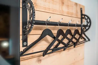a row of hangers on a wooden wall with birds on them at Three Dolphins Hotel with a Rooftop terracе in Varna City