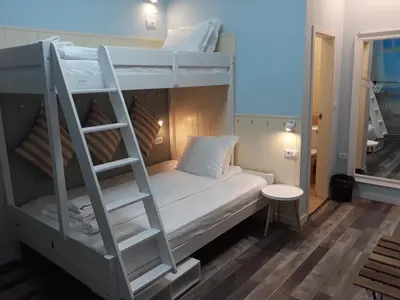 a bunk bed with a ladder in a room at Three Dolphins Hotel with a Rooftop terracе in Varna City
