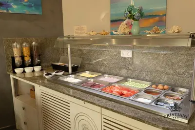 a kitchen with a counter with food on it at Cristiani Hotel Sozopol in Sozopol