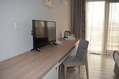 a desk with a television on top of it in a room at Cristiani Hotel Sozopol in Sozopol