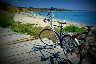 a bike parked on a path next to a beach at Relax studio by the sea, Bulgaria,Nesebar,Aheloy in Aheloy