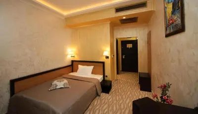 a hotel room with two beds and a door at Efbet Hotel in Varna City